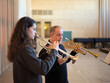© MIQUEL LLONCH/Stocksy - Teacher and student in a trumpet lesson