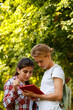 © Danil Nevsky/Stocksy - Enthusiastic students browsing tablet and looking information in park