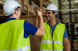 © twinsterphoto - Indian male factory warehouse worker working in logistic industry indoor. Friends greeting and doing handshake with hand grasp inside depot