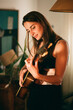 © Painted Wood/Stocksy - Portrait of a girl playing the guitar