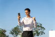 © VITTA GALLERY/Westend61 - Happy businessman gesturing while using smart phone against clear blue sky
