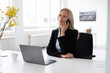© Robijn Page/Westend61 - Female entrepreneur with laptop on desk talking over smart phone in home office