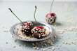 © Mandy Reschke/Westend61 - Close-up of chocolate covered cherries and quinoa in plate on table