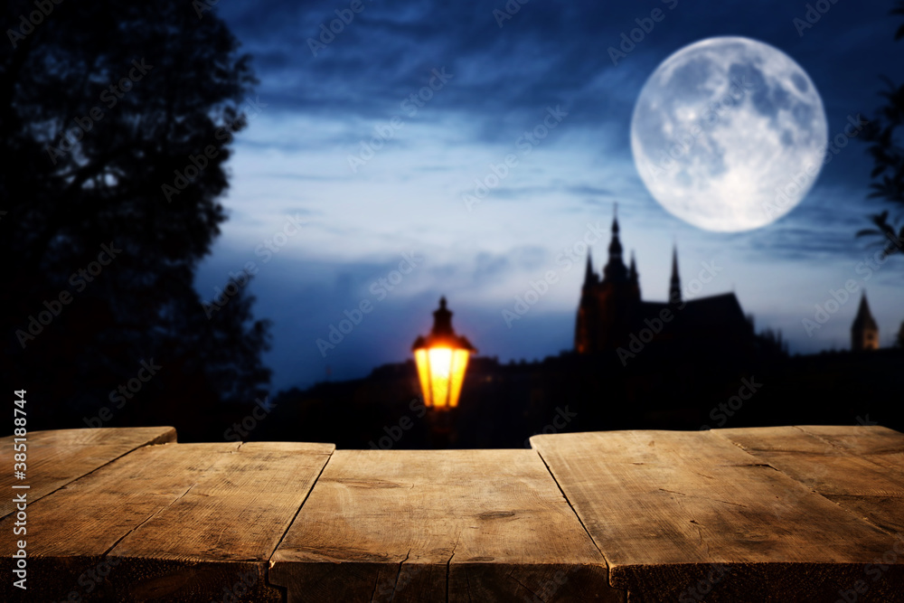 Halloween Holiday concept. Empty rustic table in front of scary night sky, forest and full moon background. Ready for product display montage - obrazy, fototapety, plakaty 