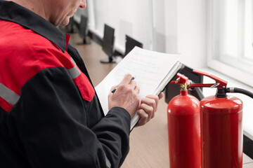 Wall Mural - engineer professional are checking a fire extinguisher and writes data to the check log. fire alarm 