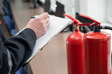 Wall Mural - engineer professional are checking a fire extinguisher and writes data to the check log. fire alarm 
