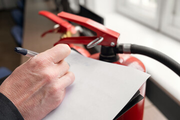Wall Mural - engineer professional are checking a fire extinguisher and writes data to the check log. fire alarm 