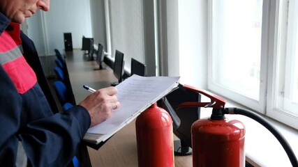Wall Mural - engineer professional are checking a fire extinguisher and writes data to the check log. fire alarm 