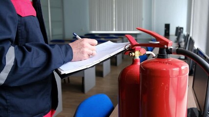 Wall Mural - engineer professional are checking a fire extinguisher and writes data to the check log. fire alarm 