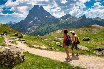 two hiker women in path of Pic du Midi Ossau in french Pyrenees mountains