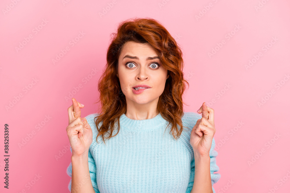 Close-up portrait of her she nice attractive lovely pretty cute scared wavy-haired girl worrying biting lip showing crossed fingers isolated over pink pastel color background - obrazy, fototapety, plakaty 