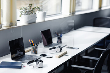 Coworking office interior, employees left room for meeting or break, nobody