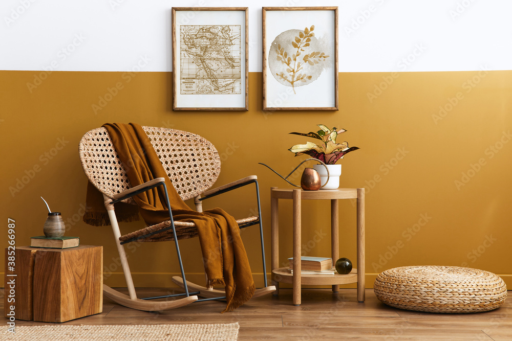 Stylish composition of living room interior with design rattan armchair, two mock up poster frames, plants, cube, palid and personal accessories in honey yellow home decor. Template. - obrazy, fototapety, plakaty 