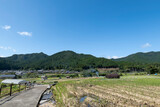 Fototapeta Na ścianę - A view of an agricultural village deep in the mountains of Japan, taken on a clear day
