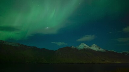 Wall Mural - brilliant aurora borealis over scenic snow capped mountain fjord iceland