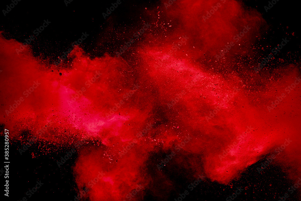 Red powder explosion on black background. Freeze motion of red dust particles splash. - obrazy, fototapety, plakaty 
