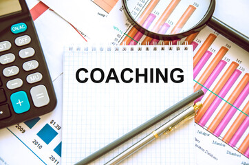coaching text written on a notebook the trainer motivates you for personal development, success and career growth.