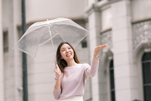 Asian Woman Holding Umbrella In Raining Season