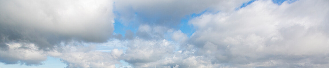 Wall Mural - Image of a partly cloudy and partly clear sky during the day
