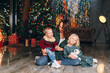 © irina_timokhina - Cute mother with daughter and son posing at the Christmas tree