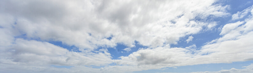 Wall Mural - Image of a partly cloudy and partly clear sky during the day