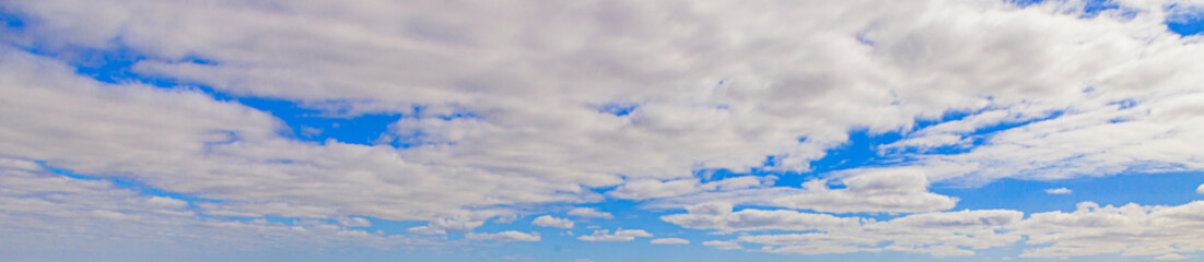 Wall Mural - Image of a partly cloudy and partly clear sky during the day