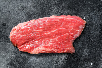 Raw flank steak. Marble beef black Angus. Black background. Top view