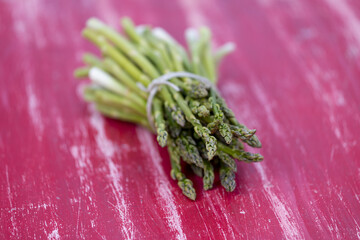 Sticker - green asparagus on a red table