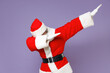 © ViDi Studio - Santa Claus man in Christmas hat red suit coat doing dab hip hop dance hands gesture, youth sign hiding covering face isolated on violet background. Happy New Year celebration merry holiday concept.