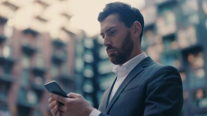 Portrait young attractive businessman stand use smartphone look around at city center. Handsome man messagen stylish. Employment technology suit. Slow motion