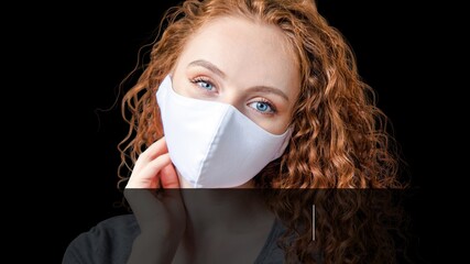 Young girl in mask in black background. Mask protects you and your health. Coronavirus Pandemic