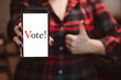© Galina Atroshchenko - Woman holds phone in her hands. Online voting and elections concept.