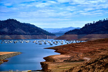 Scenic View Of Lake Oroville Dam, Lake Boathouses And Mountain View In Lake Oroville California .