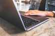 © Farknot Architect - Closeup image of a woman working and touching on laptop computer touchpad on the table