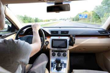 Wall Mural - The young man driving the modern car on asphalt road