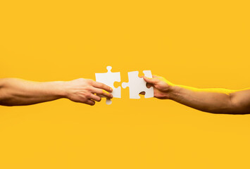 Man hands connecting couple puzzle piece. Business solutions, target, success, goals and strategy concepts. Hand connecting jigsaw puzzle. Business solutions, success and strategy concept