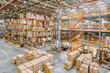 © nordroden - Large industrial warehouse. Tall racks are completely filled with boxes and containers.