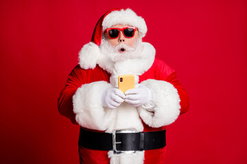 Sticker - Photo of retired old man grey beard hold telephone shocked impressive news north pole flight available wear santa x-mas costume gloves coat sunglass headwear isolated red color background