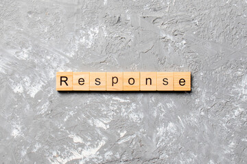 Wall Mural - RESPONSE word written on wood block. RESPONSE text on cement table for your desing, concept