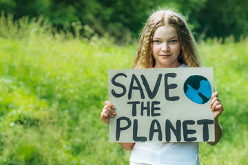 happy smiling child looking to camera holding a colorful save planet ecology poster. a school girl kid voted for forest protection from trash pollution. educational project for nature protection.