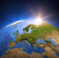 Wall Mural - surface of the planet earth viewed from a satellite, focused on europe, sun rising on the horizon. p