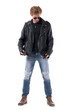 © sharplaninac - Stylish biker or rock subculture man put on leather jacket getting dressed. Full body isolated on white background.