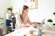© AntonioDiaz - Woman writing an email in her office