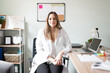 © AntonioDiaz - Pretty dietician sitting at her office