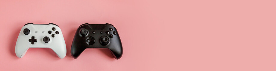 Sticker - White and black two joystick gamepad game console isolated on pastel pink colourful background. Computer gaming competition videogame control confrontation concept. Cyberspace symbol Banner