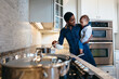 © Gerald Carter/Creative Flame - Black mother and son in kitchen preparing food for family dinner