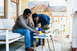 © Gerald Carter/Creative Flame - Mom and dad play games with toddler on front porch of family home