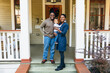 © Gerald Carter/Creative Flame - Potrait of black family and child in front of home for the holidays