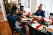 © Gerald Carter/Creative Flame - Black multigenerational family eating Kwanzaa holiday meal