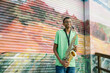 © Lynsey Weatherspoon/Creative Flame - Portrait of Black male teenager playing saxophone at school on colorful background